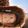 Detailed view of an excavator on sandy terrain by Alappuzha's shore, showcasing engineering strength.
